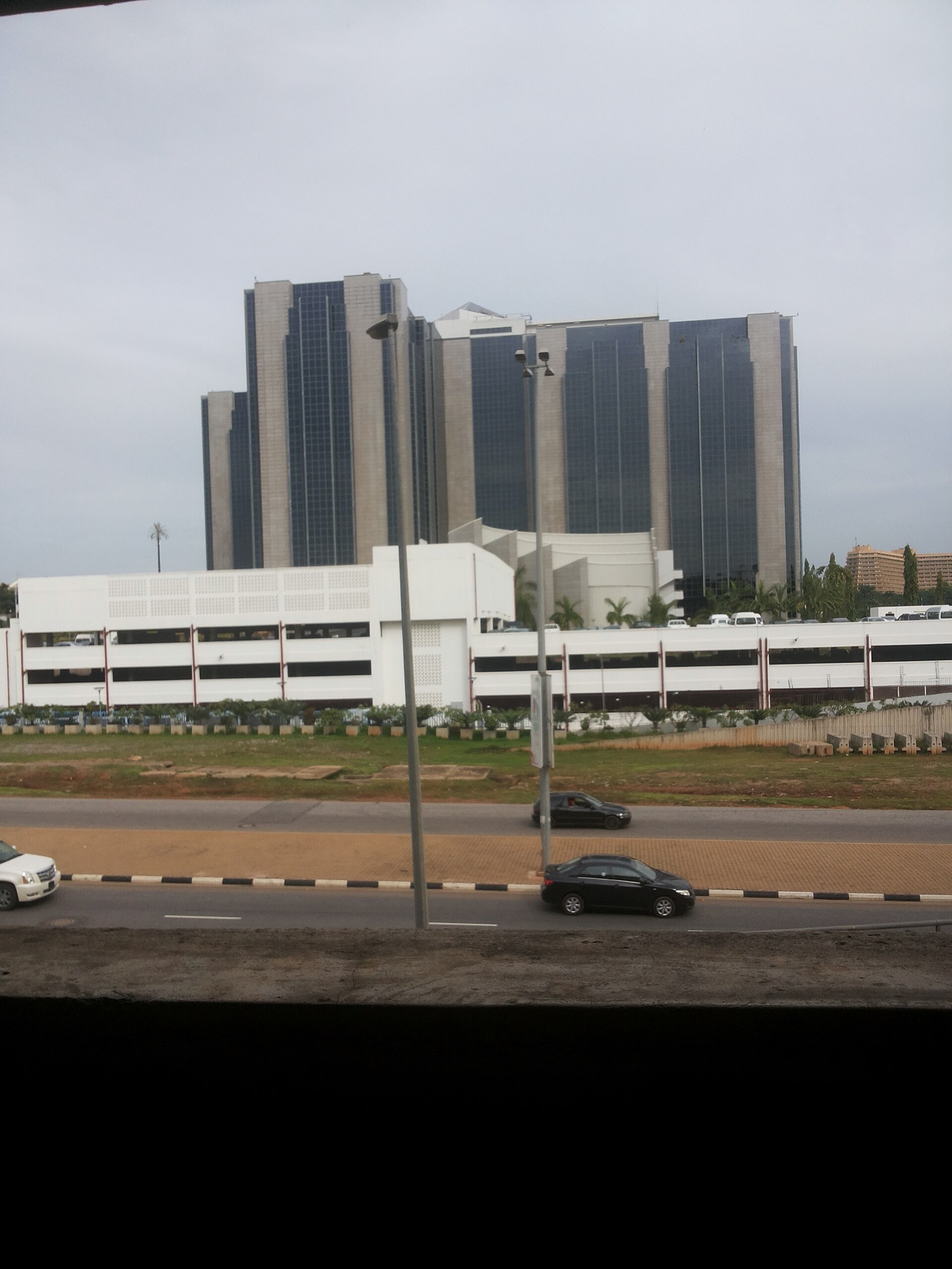 The twin-tower headquarters of the Central Bank of Nigeria in Abuja beside a highway