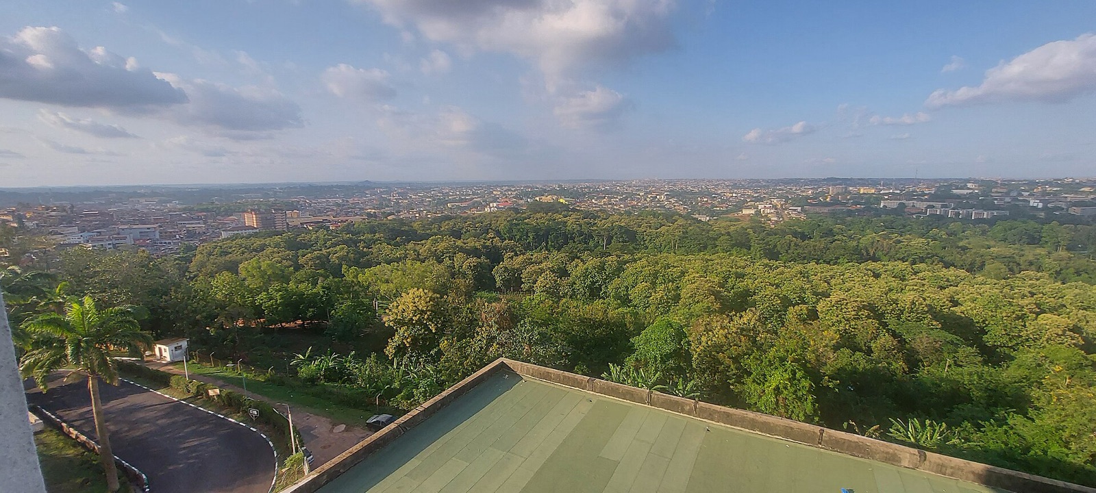 An aerial view across Ibadan’s rooftops and green tree cover