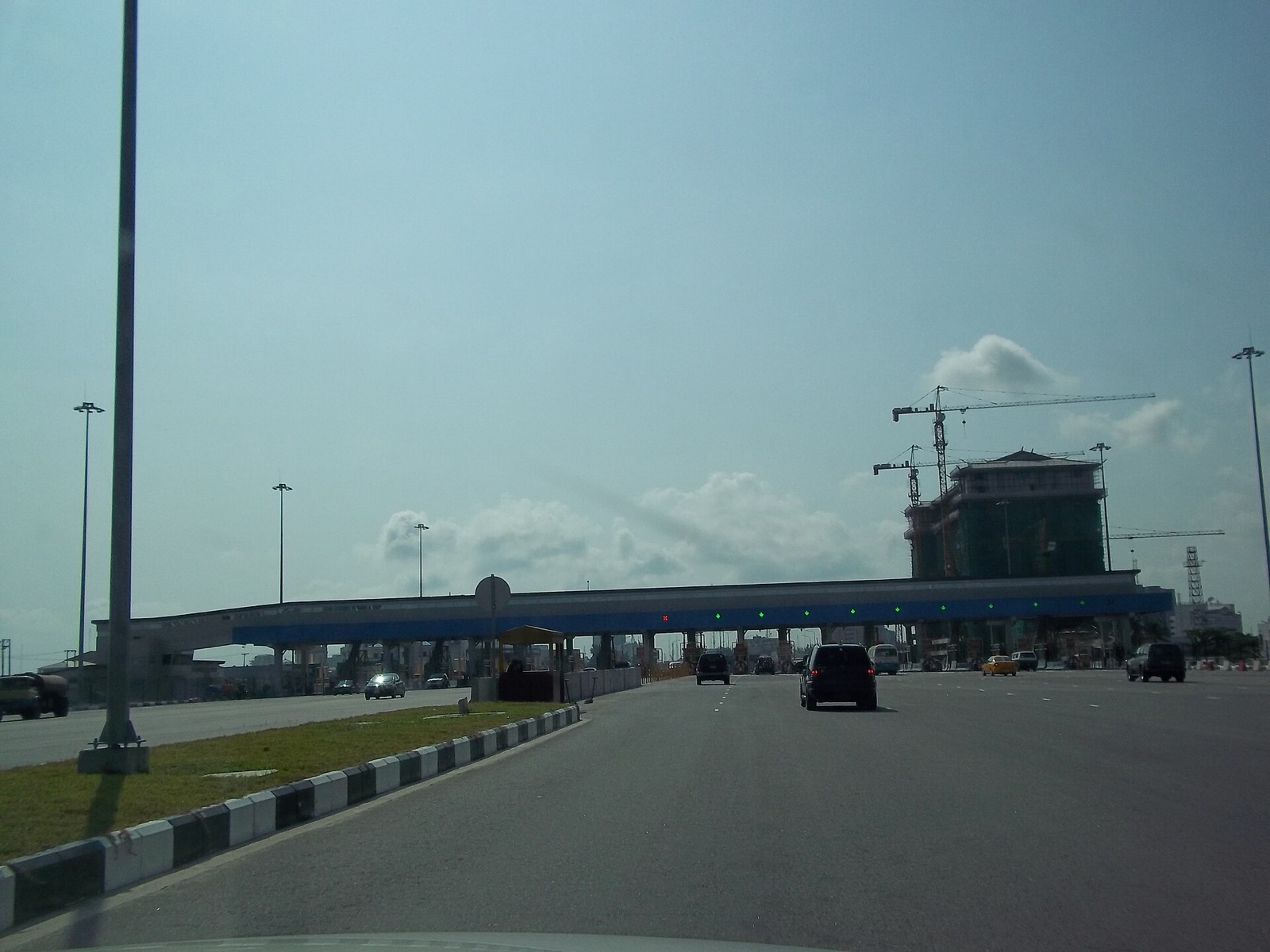A wide dual carriageway leading to a toll gate on the Lekki–Epe corridor in Lagos