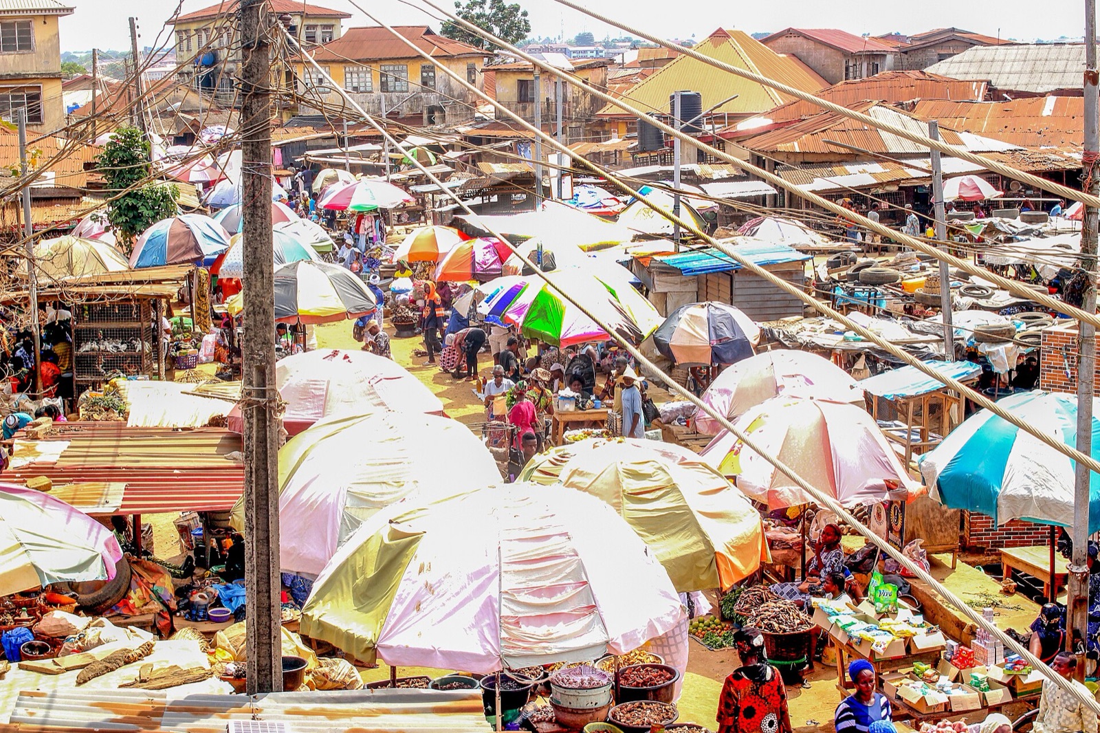 Rows of colourful umbrellas shading traders on market day in Ikorodu, Lagos